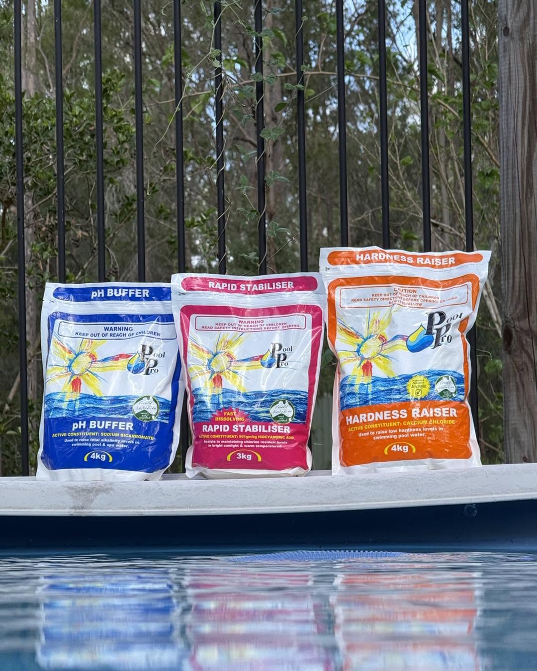 Pool Pro chemical bags standing on the edge of a clear pool.